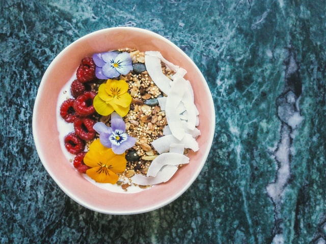 Smoothie bowl fruit with edible flowers and coconut raw foods alive foods